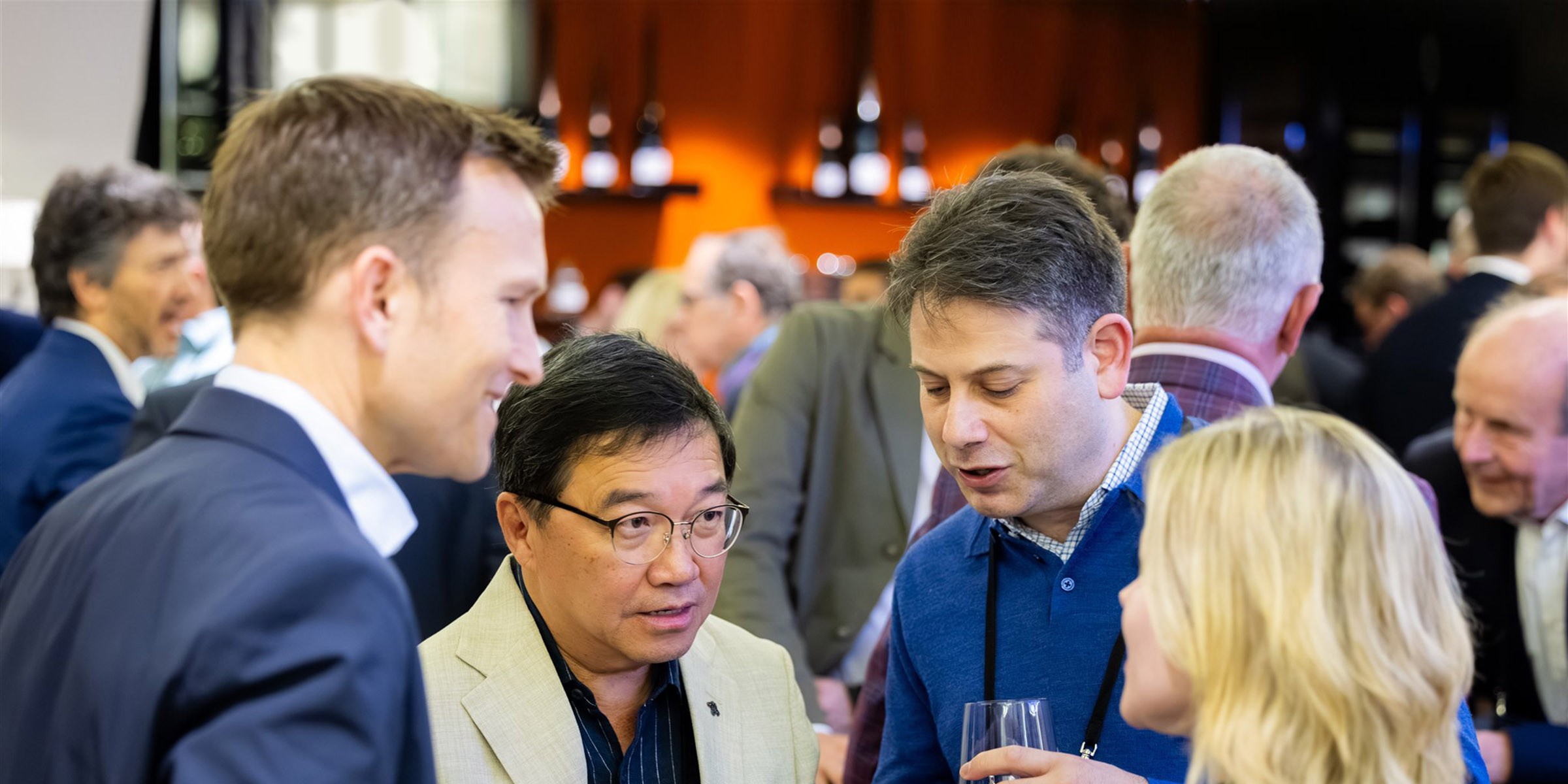 Business people standing talking in a group in a hotel bar