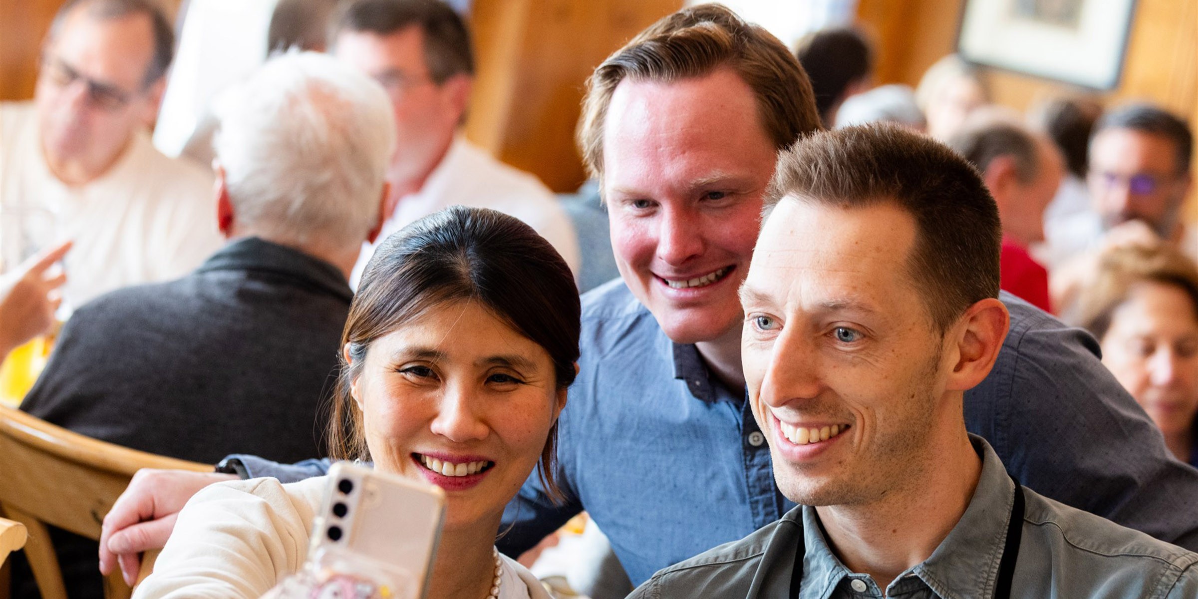 Three happy business people taking a selfie