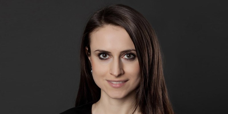 Head image of woman, with long dark hair